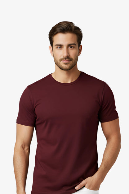 Man wearing a maroon t-shirt with white deux vincente logo on sleeve