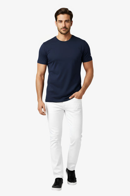 Man wearing a navy blue t-shirt with white deux vincente logo on sleeve and white pant