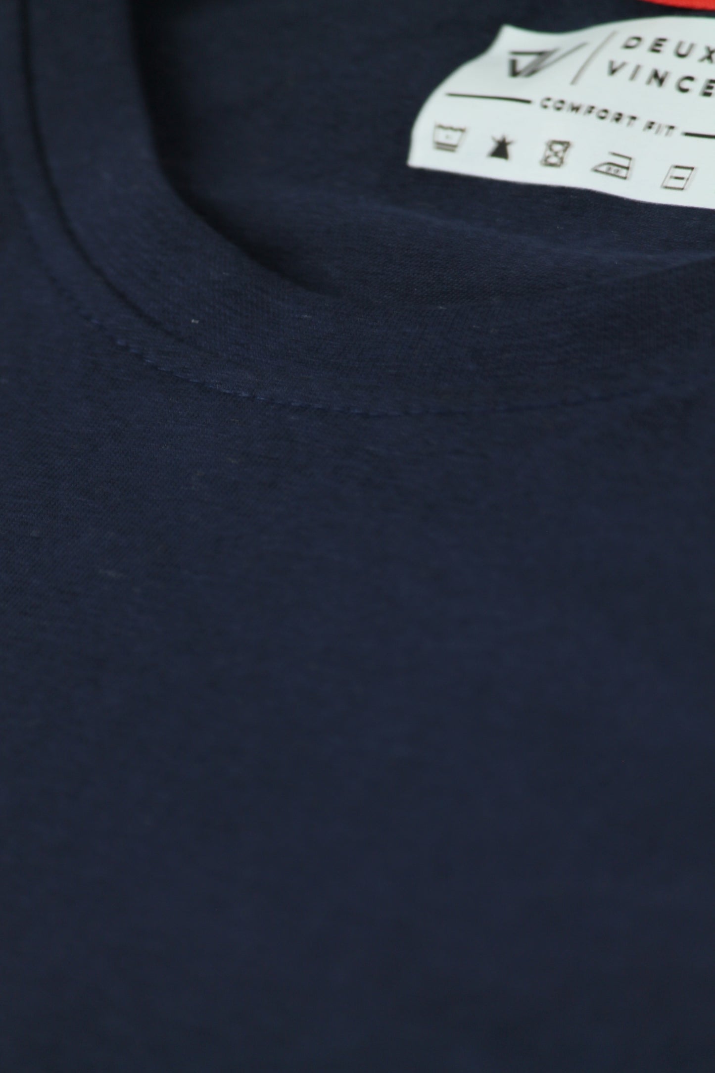 Navy blue t-shirt with a brand label on the collar