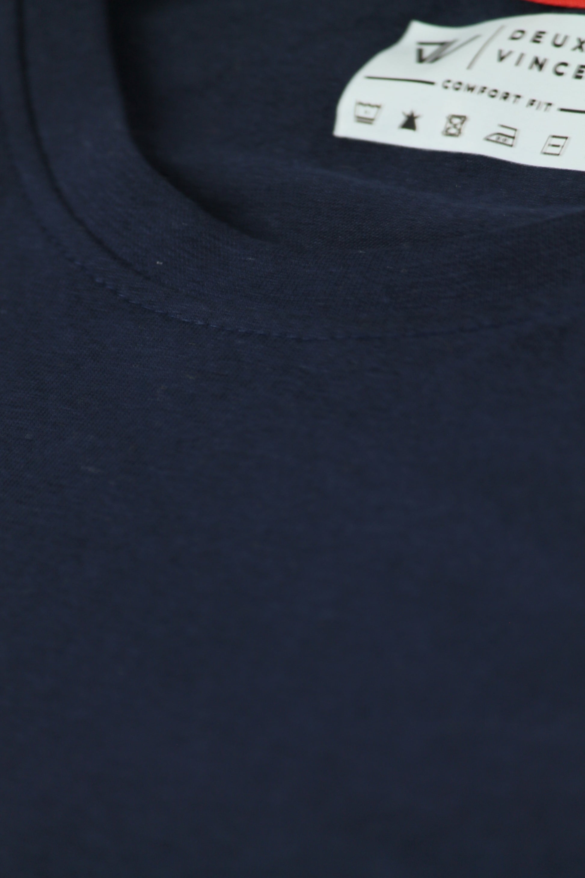 Navy blue t-shirt with a brand label on the collar