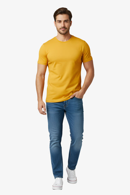 Man wearing a yellow t-shirt with white deux vincente logo on sleeve and denim jeans