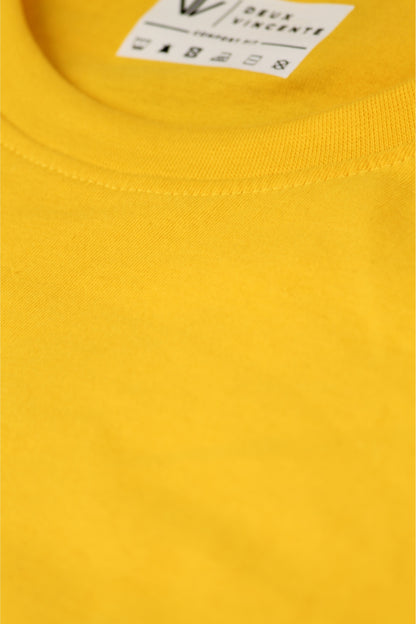 Close up of neckline of a yellow deux vincente t-shirt