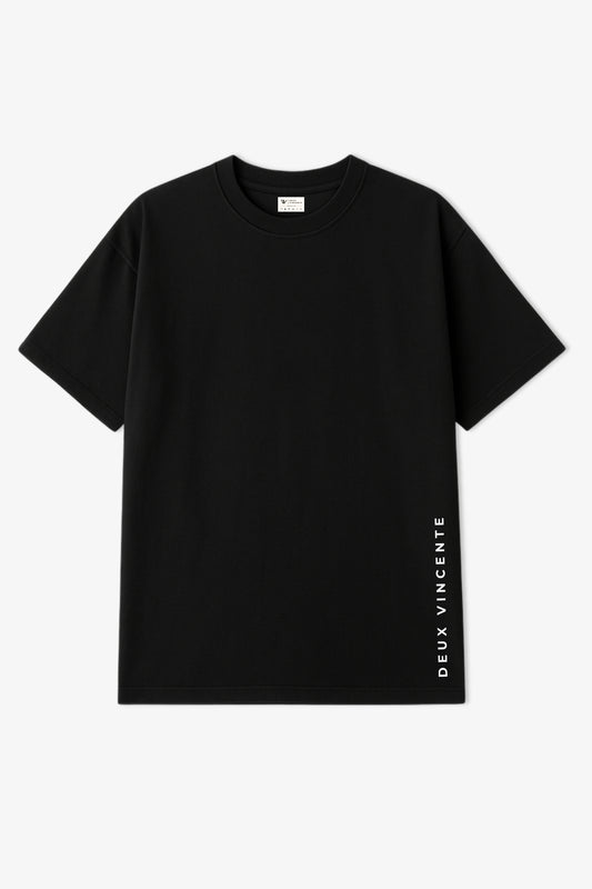 Flat lay of black oversized t-shirt with white deux vincente text placed vertically along the left edge