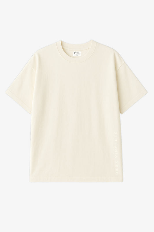 Flat lay of off white oversized t-shirt with light deux vincente text placed vertically on left edge